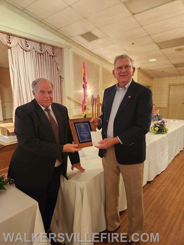 President Jim Graham presenting Vaughn Zimmerman with a Special Recognition Award for his dedication to being a weekly bingo 'caller.'