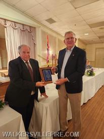 President Jim Graham presenting Vaughn Zimmerman with a Special Recognition Award for his dedication to being a weekly bingo 'caller.'